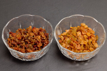 brown and golden raisins in glass bowls