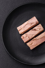 Delicious canned dietary tuna meat with salt, spices and oil