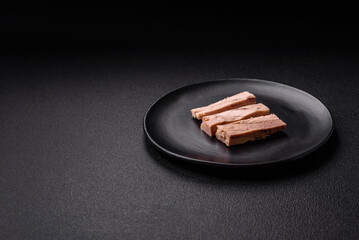 Delicious canned dietary tuna meat with salt, spices and oil