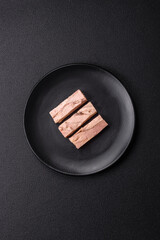 Delicious canned dietary tuna meat with salt, spices and oil