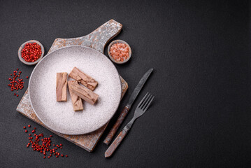 Delicious canned dietary tuna meat with salt, spices and oil