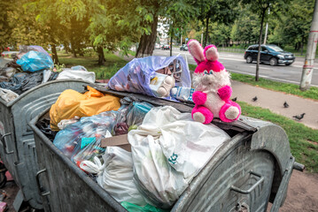 Pink plush rabbit on the garbage can