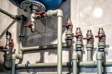 Plumbing service. plastic pipeline and expansion tank of a heating system in boiler room
