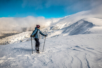 Fototapeta na wymiar Tourist hiker in winter snowy mountains