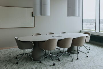 Empty conference table with chairs in board room