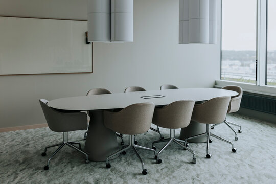 Empty conference table with chairs in board room