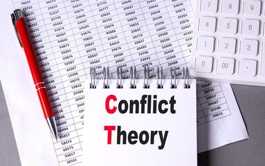 CONFLICT THEORY text on notebook with pen, calculator and chart on grey background