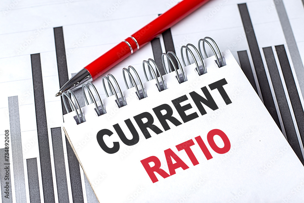 Poster current ratio text written on notebook with pen on chart