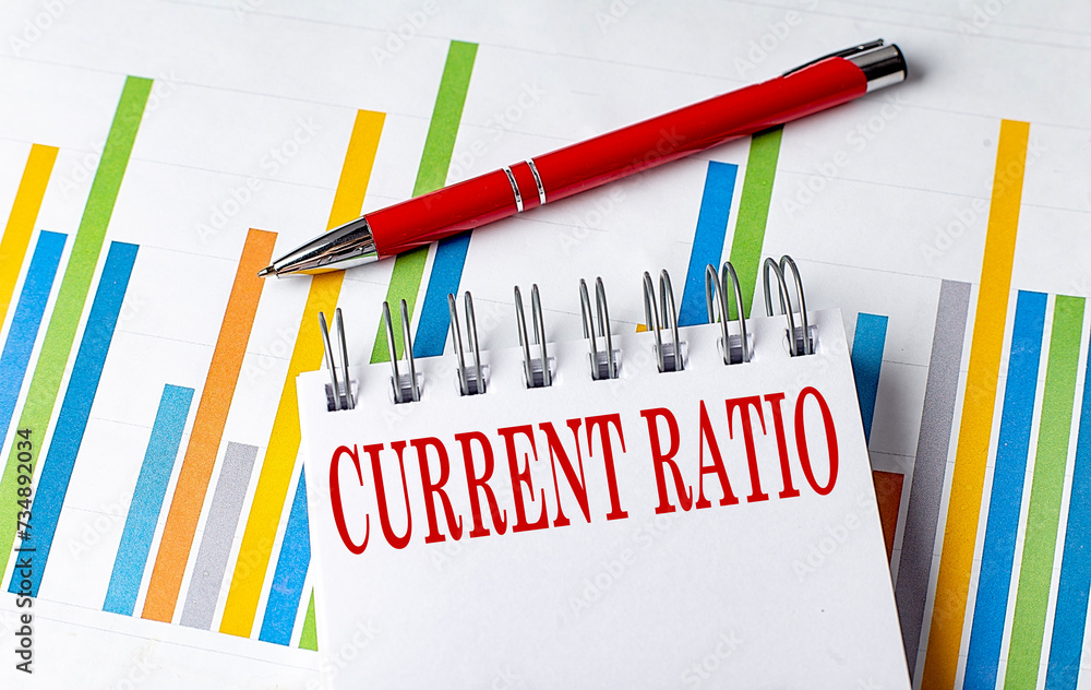 Poster current ratio text on a notebook with chart and pen business concept