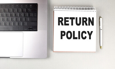RETURN POLICY text on notebook with laptop and pen