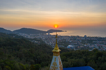 aerial view scenery sunset above pagoda of Doi Thepnimit temple on the highest of Patong...