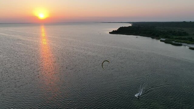Aerial view of sunset in Hel penisula Jastarnia Puck Bay Baltic Sea. Kitesurfing at sunset. Windsurfing at sunset. Water sports at sunset on sea.