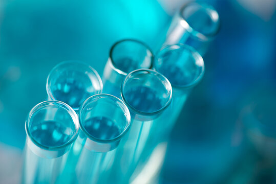 Chemical test tubes close-up with blue liquid. Medicine, pharmaceuticals, chemistry