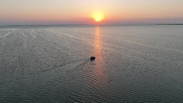 Aerial view of sunset in Hel penisula Jastarnia Puck Bay Baltic Sea. Kitesurfing at sunset. Windsurfing at sunset. Water sports at sunset on sea.