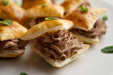 Miguelitos de la roda de chocolate. Spanish Desserts made with puff pastry and chocolate cream.