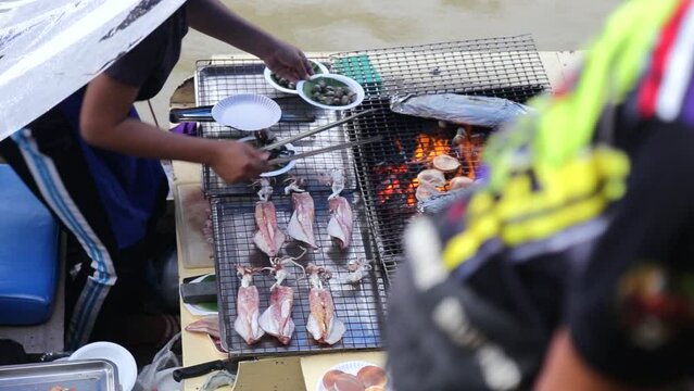 Grilled Seafood of Boat Merchat in Ampawa Floating Market Thailand