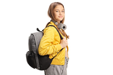 Female teen student with headphones and backpack