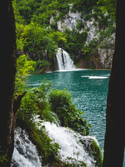 Beautiful waterfall surrounded by lush greenery in Plitvice Lakes National Park. Croatia