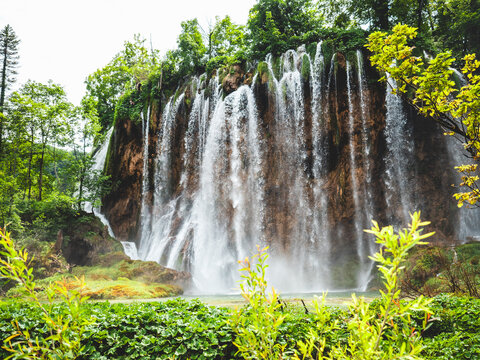 Beautiful waterfalls surrounded by lush greenery in Plitvice Lakes National Park. Croatia