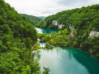 Fototapeta na wymiar Scenic view of lush green forest and a serene river in Plitvice Lakes National Park, Croatia