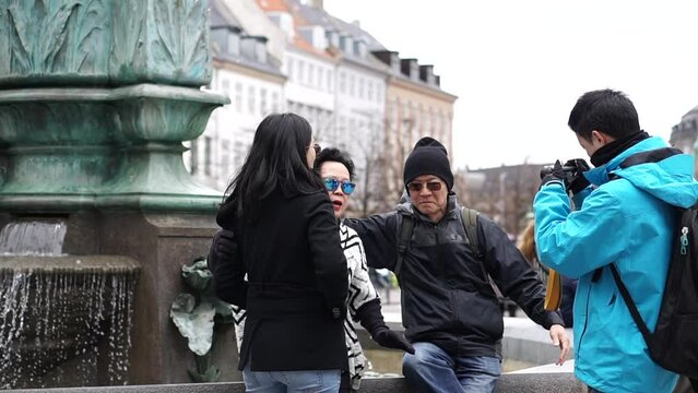 Copenhagen, Denmark Amagertorv square Stork fountain Asian family tourist taking photo fun beautiful Europe trip
