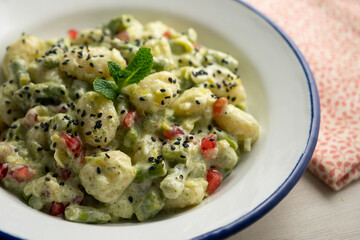 Gnocchi with yogurt sauce and asparagus. Italian potato gnocchi with traditional sauce.