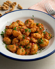 Gnocchi with pesto rosso sauce. Italian potato gnocchi with traditional sauce.