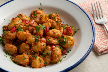 Gnocchi with pesto rosso sauce. Italian potato gnocchi with traditional sauce.