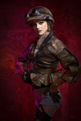 A girl with stylish makeup is dressed in post-apocalypse and cyberpunk style against the background of iron rusty wall