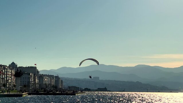 Cityscape of Izmir and parasailing 