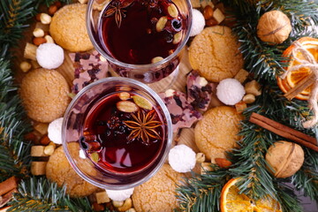 Festive composition on the theme of Christmas with mulled wine, a wreath of coniferous branches and...
