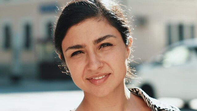 Young beautiful smiling hipster woman in trendy summer zebra print costume clothes. Carefree model posing in the street at sunset. Positive brunette female. Cheerful and happy. In sunglasses
