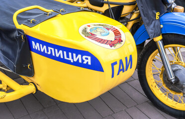 Inscription "Militsia" (Police) and emblem of the former soviet union on the board of russian police motobike