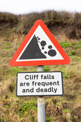 Sign warning people of potential cliff falls on Dunwich Beach, Suffolk. UK