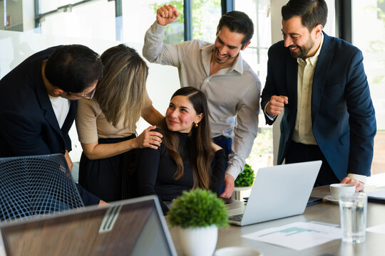 Businesswoman getting recognition from her colleagues at work