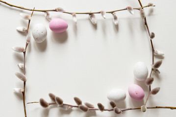 Easter composition with a willow branch and white quail eggs on a light gray background. Springtime and Easter holiday concept with copy space. Top view, Flat lay - obrazy, fototapety, plakaty