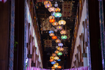 Doha, Qatar-April 20,2023: In the Old market Souk Waqif a decorative, traditional, glass mosaic lamps hanging.