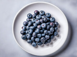 round plate with blueberries top view on a white isolated background. blueberries in a bowl