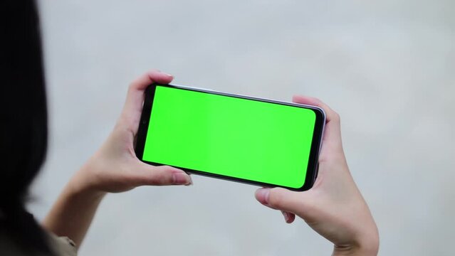 Asian Woman Play on Smartphone With Green Screen