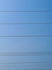 The sky and the electrical wires arranged in lines