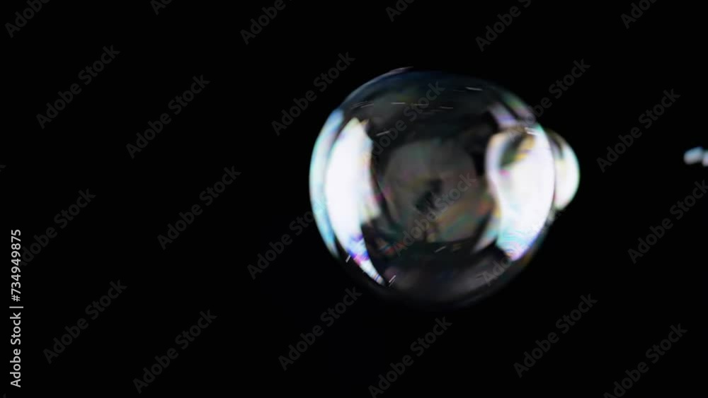 Poster lot of colorful soap bubbles fly on a black background in empty space. blowing. large and small stic