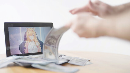 Throwing money at the anime girl vtuber on monitor screen
