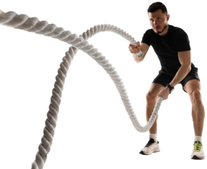 Concentrated athletic man training, doing workout exercises with rope isolated on transparent background. Concept of sport, fitness, workout, healthy and active lifestyle