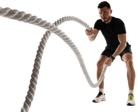 Concentrated athletic man training, doing workout exercises with rope isolated on transparent background. Concept of sport, fitness, workout, healthy and active lifestyle