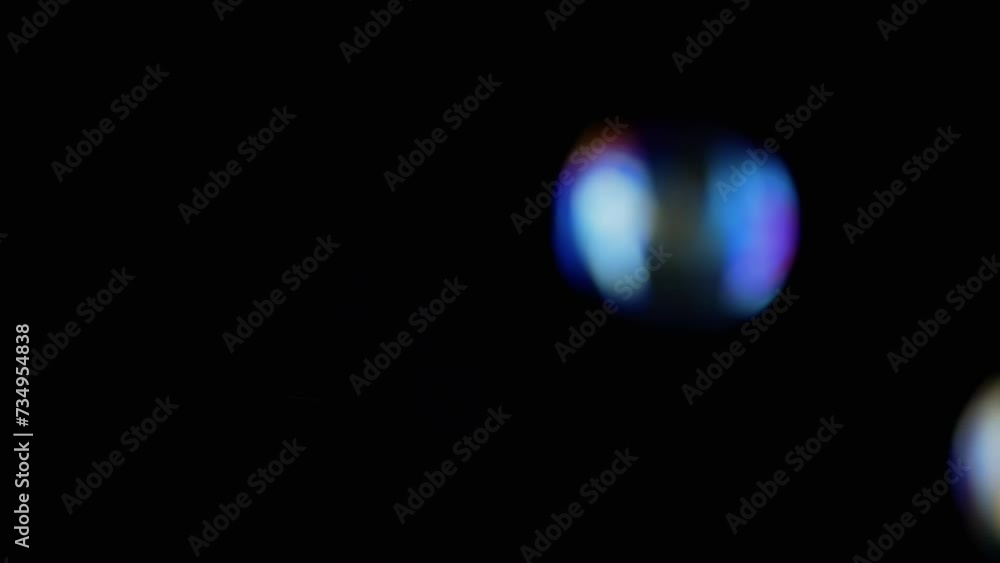 Poster lot of large colorful soap bubbles fly on a black background and burst. blowing. splash, foam. fast 