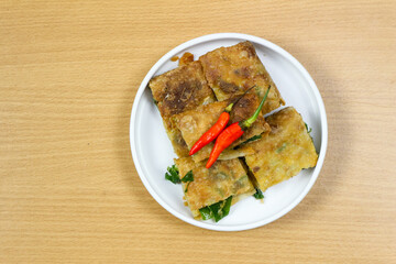 Martabak Telor or Martabak Telur. Savory pan-fried pastry stuffed with egg, meat and spices. Martabak Telur is one of Indonesia street food