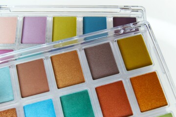 Eye shadow palettes on a light background. Close-up of makeup palettes.