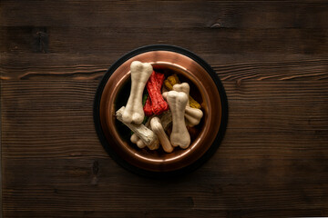 Bowl full of chew bones for dog. Food and treats for pets