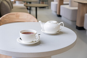 Fototapeta na wymiar Cup of tea and teapot