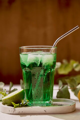 Refreshment healthy detox citrus green sparkling mocktail. Non alcoholic vitaminized healthy beverage. Green Appletini Mocktail for St. Patricks Day.